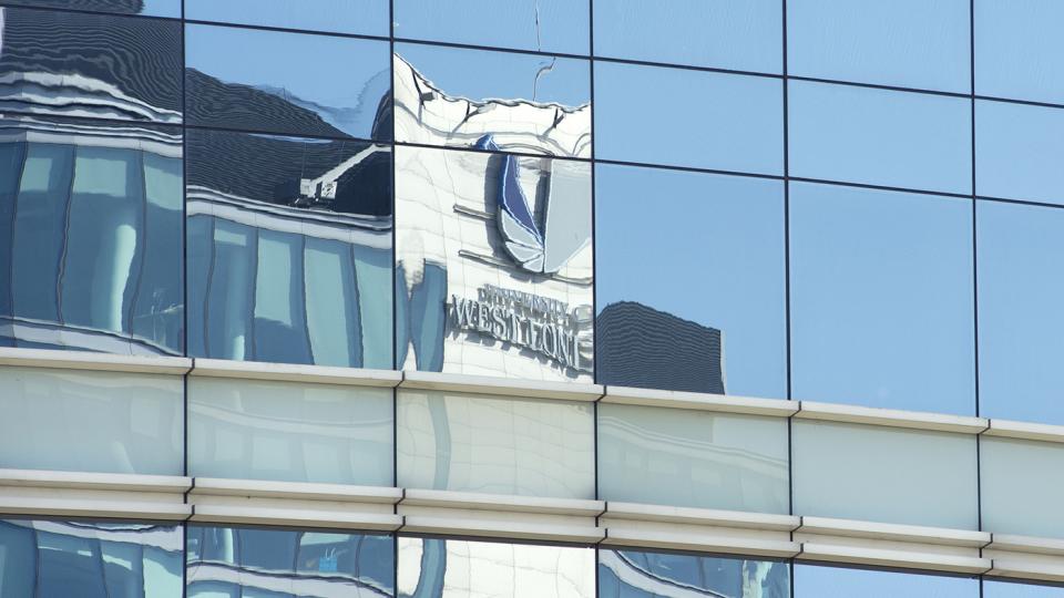 The University of West London logo, reflected in glass