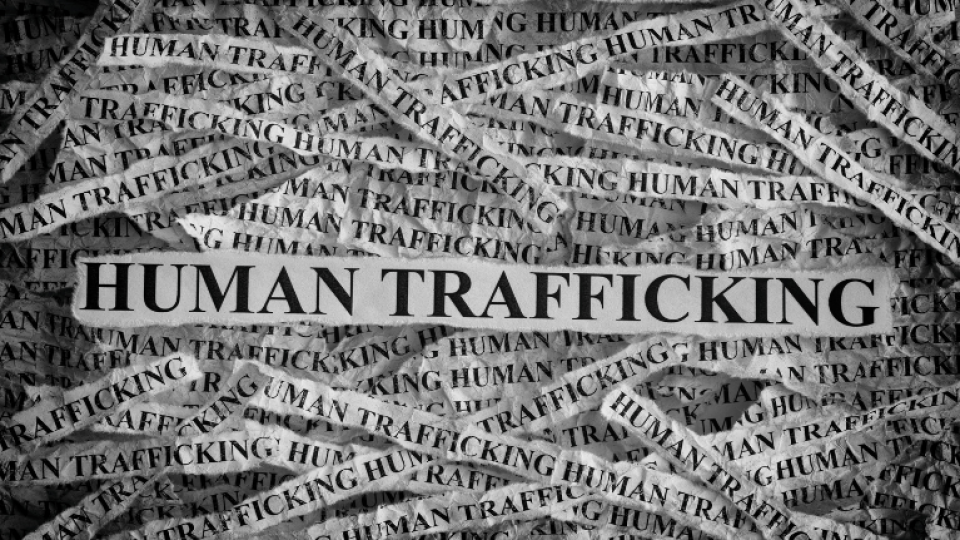 A large banner that says 'human trafficking' repeatedly
