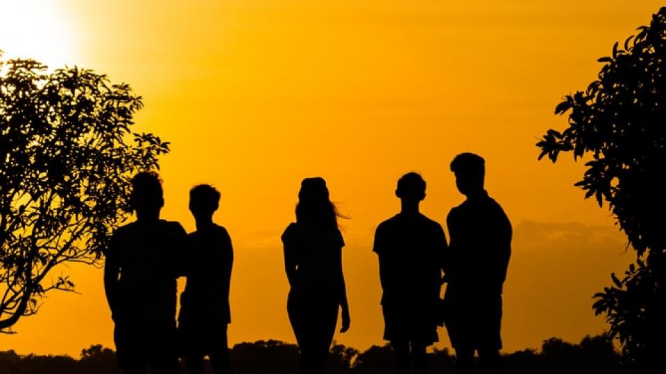 a group of people at sunset