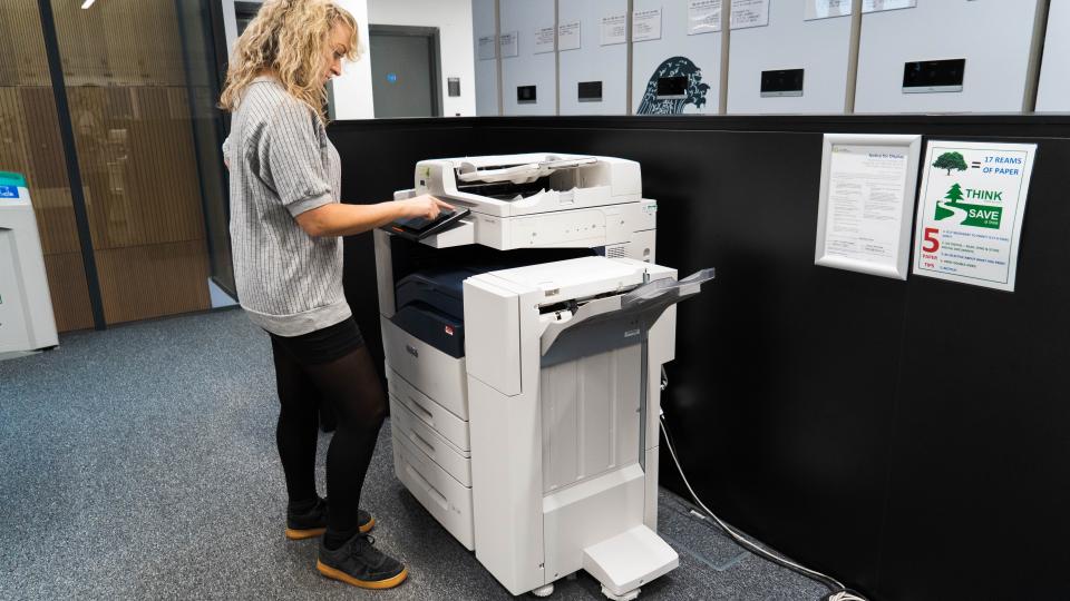 A female student using the photocopier in the Library