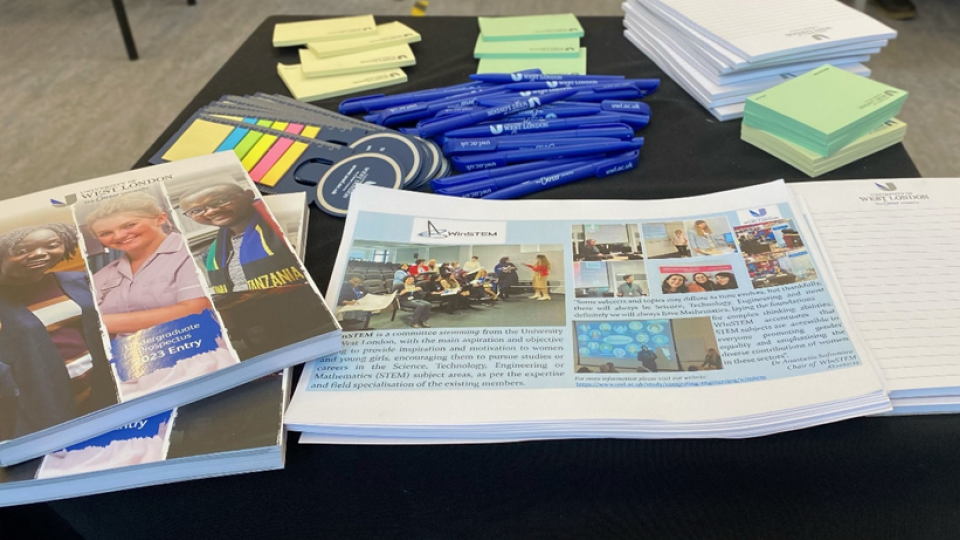 A selection of undergraduate brochures, pens, posted notes and other stationery on a table.