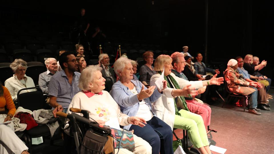 An audience of older people at an opera