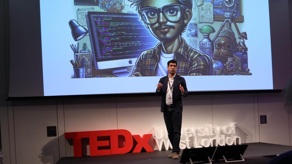 Kashif Iqbal (SEGA) speaking onstage at the TEDx University of West London event