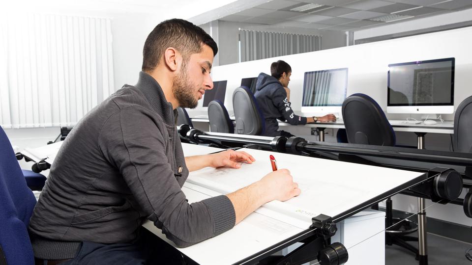 A male student working at a architecture desk