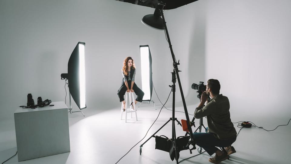 A woman having her photo taken in a studio