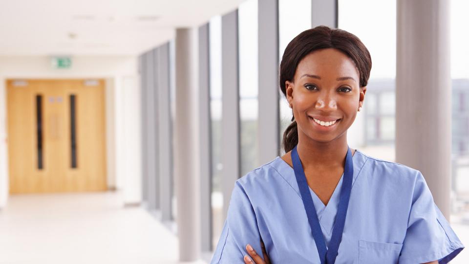 A smiling nurse in scrubs 