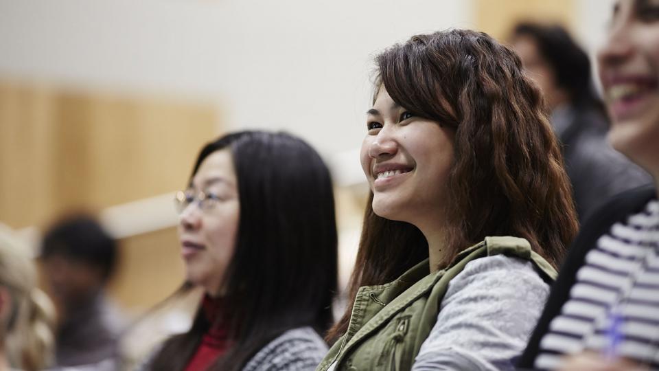 A female student smiling during a lecture