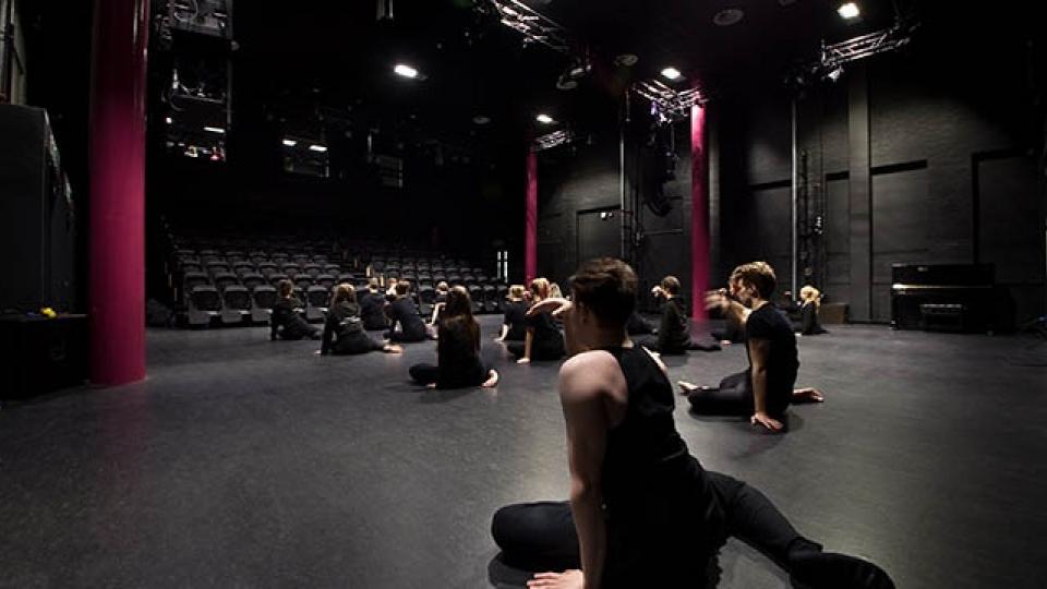 Dancers sitting in the Lawrence hall studio theatre
