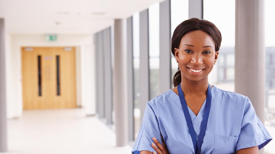A smiling nurse on a hospital ward