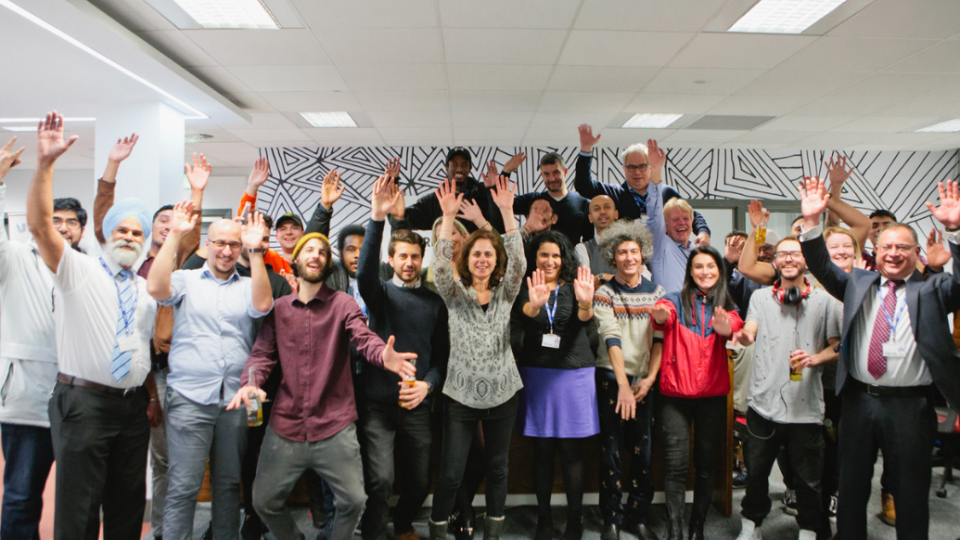 A group of people with their arms raised at Westmont Enterprise Hub