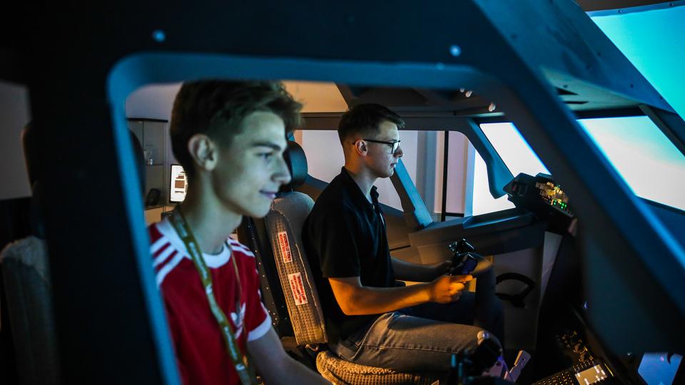 Two pilots in a simulator cockpit
