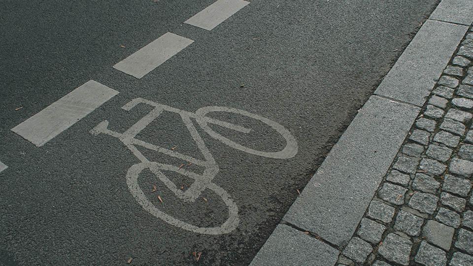 a bicycle painted on a road to mark a cycle lane