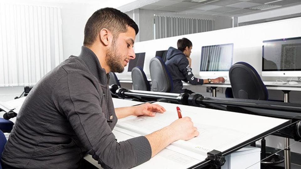 two students working in the computer laboratories architecture studio at UWL