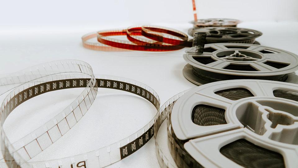 Four film reels pictured on a white table