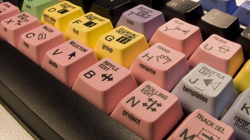 Close up of a video editing keyboard with brightly coloured keys