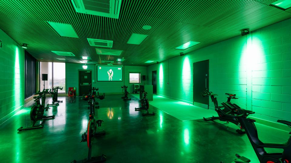 Indoor space for group cycling classes with neon green lighting