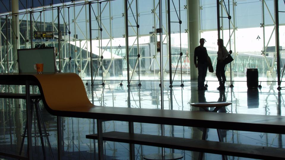 two passengers wait in an airport