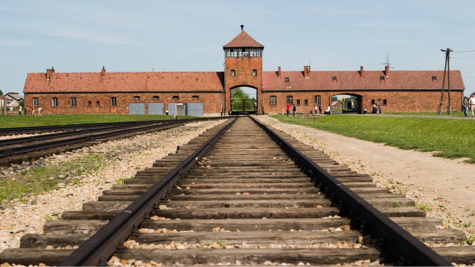 train track leading to the Auschwitz concentration camp building