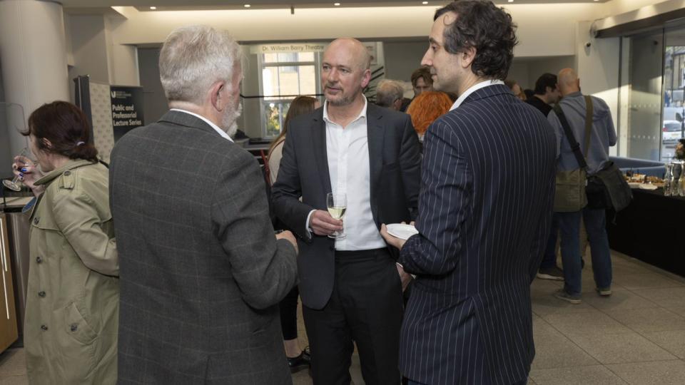 Professor Garing Dowd speaking with colleagues at the Samuel Beckett event