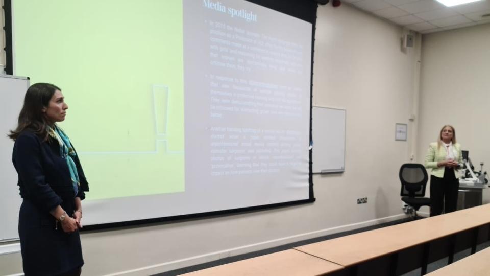 Maryam Ferydoun speaking in front of a presentation at WInSTEM event