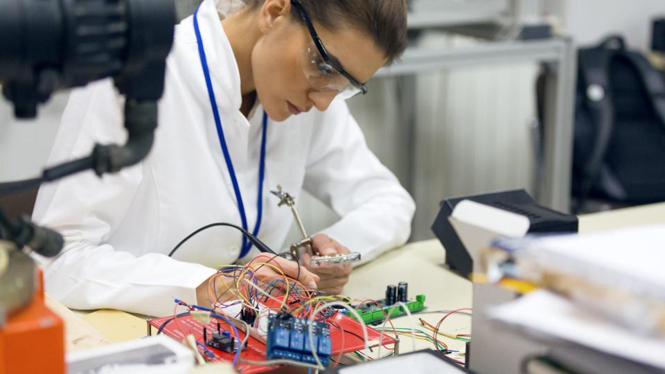 A students works on an electronics circuit