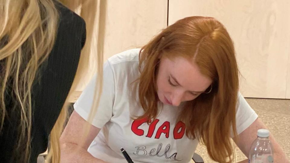 Dr Hannah Fry signing a copy of her book