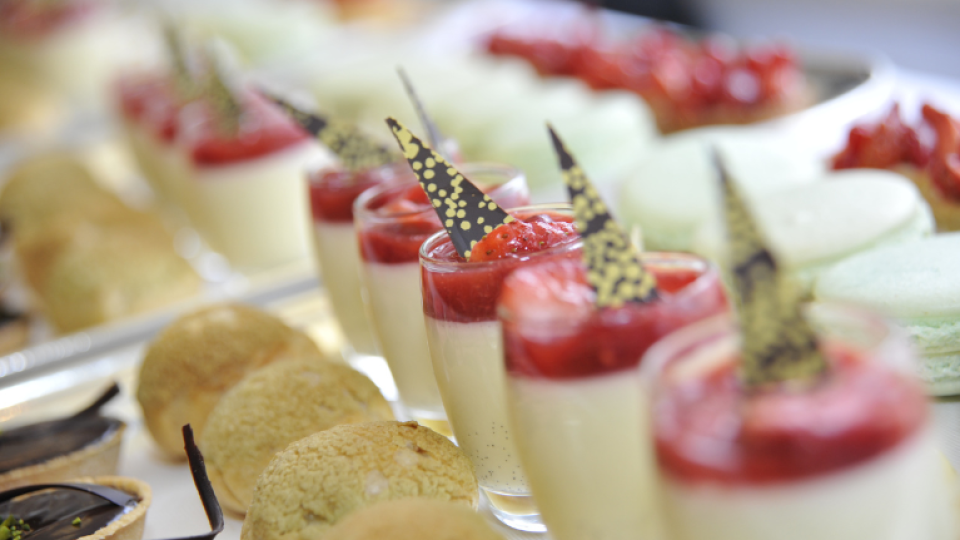 Identical fruit desserts in glasses, served with a small biscuit.
