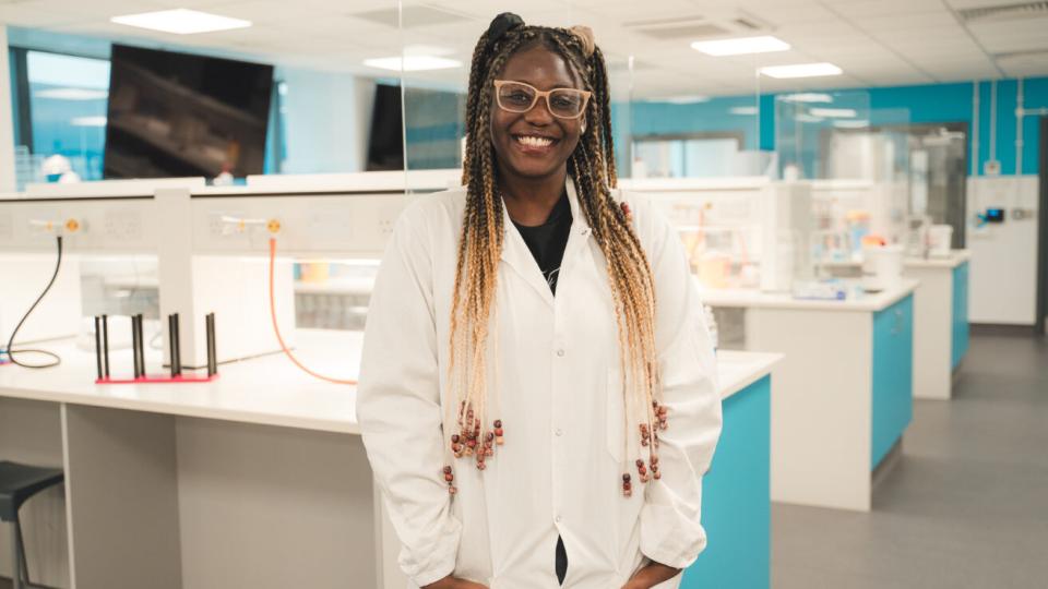 A UWL student standing and smiling in one of our labs