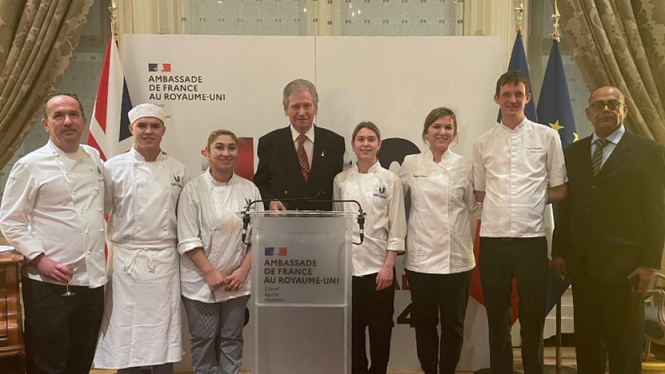 Student chefs posing with Michel Escoffier at the University of West London