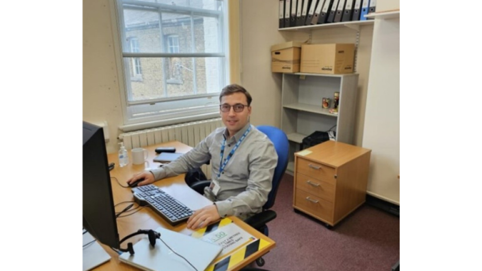 Nazar Dragun is sat down at a computer wearing a smart shirt.
