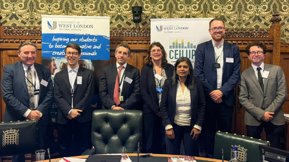 Professor Peter John and Professor Graeme Atherton from the University of West London stood with participants in a discussion at the House of Commons