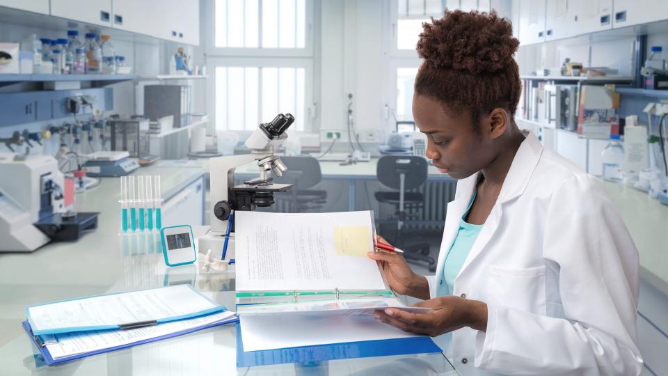 A female doctor making notes in a laboratory 
