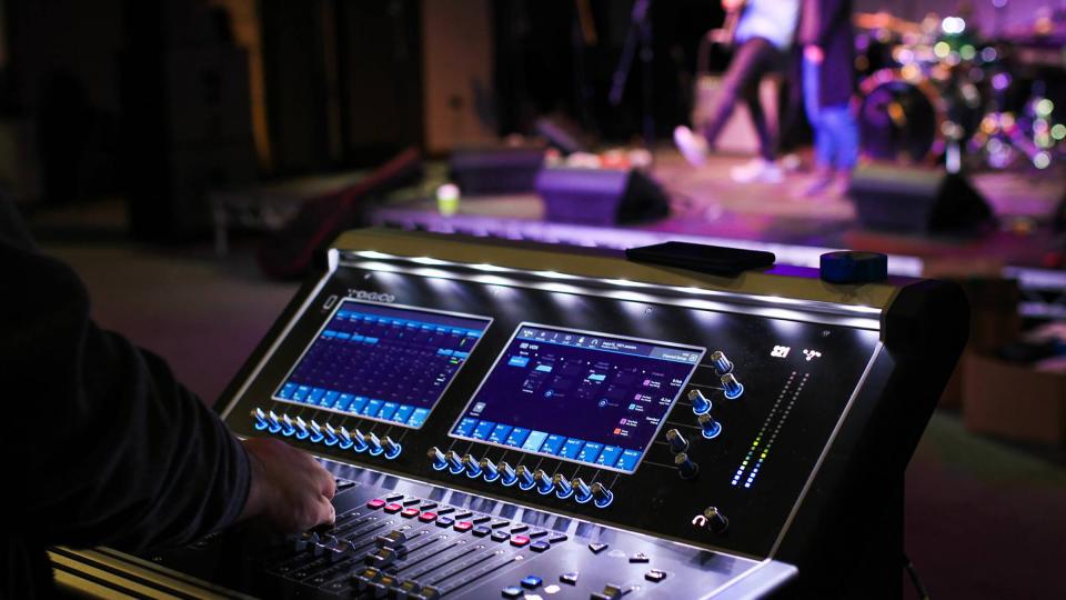 Someone operating a sound desk during a dress rehearsal