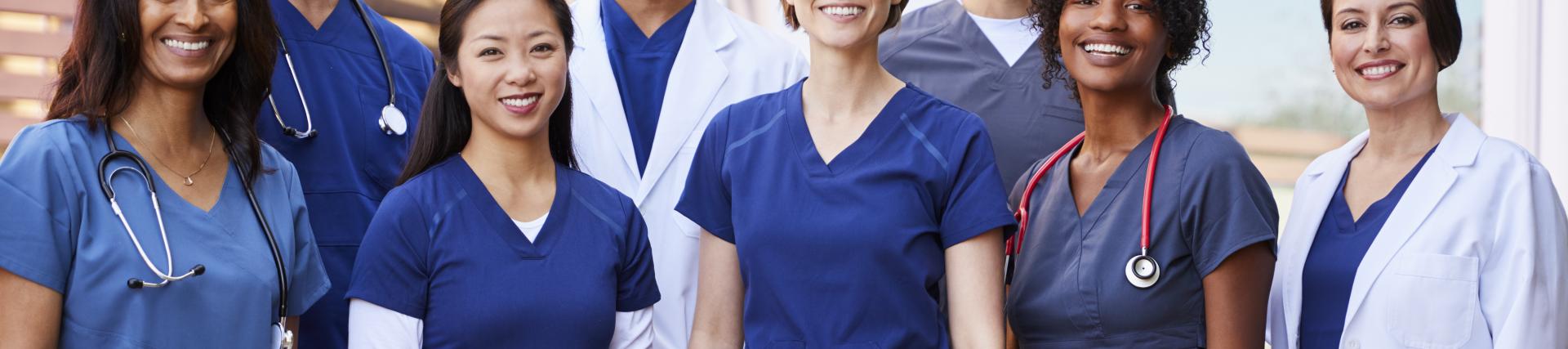 Large team of medical staff standing together smiling
