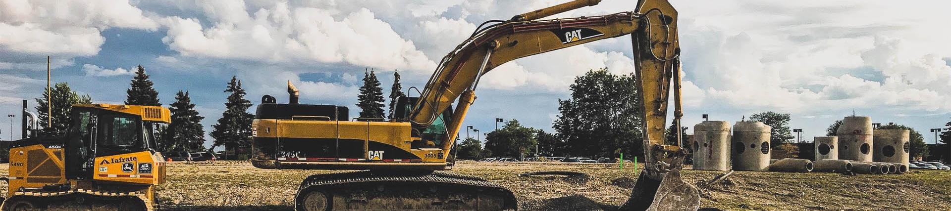 A Caterpillar excavator on a road-side building site