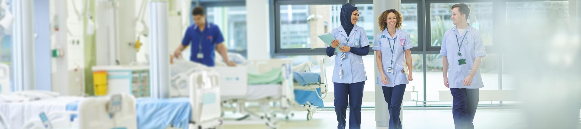 Student nurses walks through a hospital ward