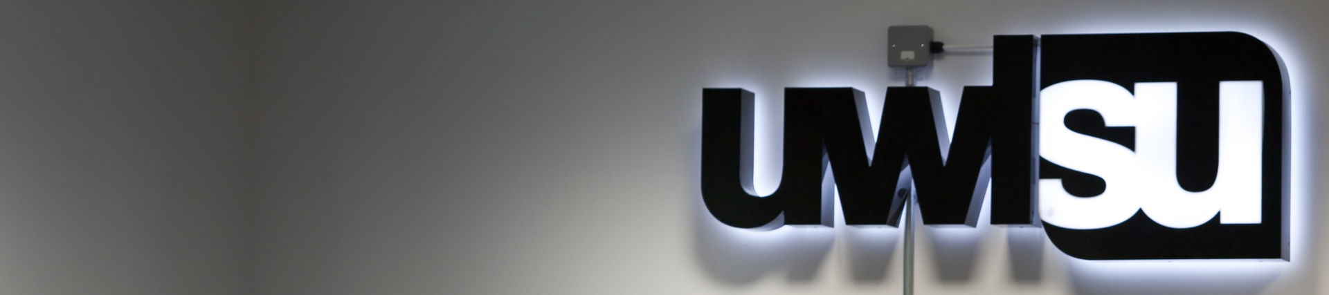 The UWLSU logo, mounted on a wall in the Student's Union