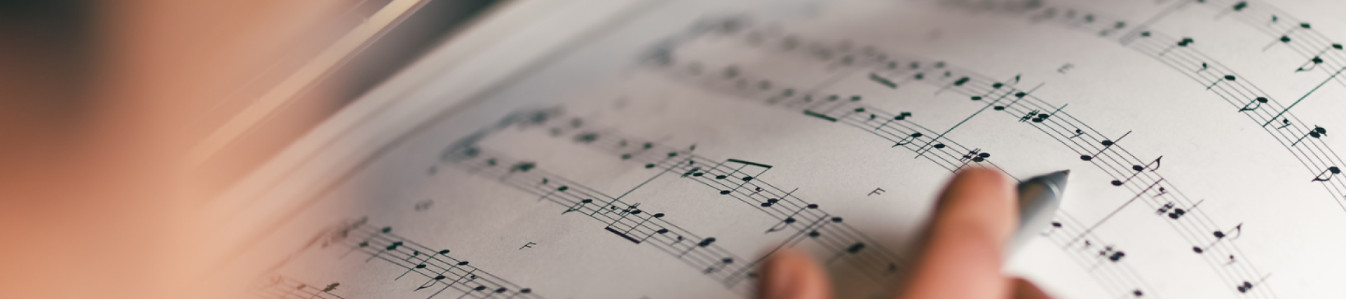 Student composes music on a manuscript
