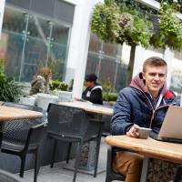 Man working on laptop smiling