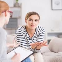 Woman talking to a counsellor making notes