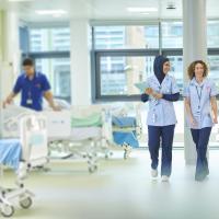 Student nurses walks through a hospital ward