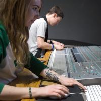 A female and male student at a sound desk