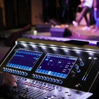 Someone operating a sound desk during a dress rehearsal