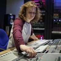 A student operating a sound desk