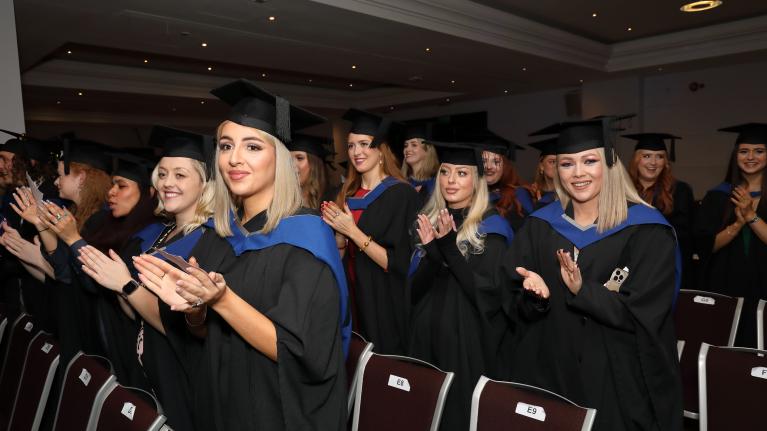 Students celebrating graduation at Twickenham Stadium