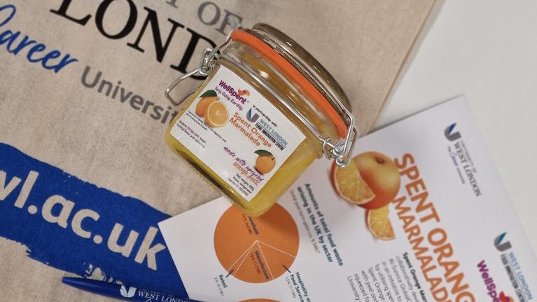 Spent Orange Marmalade jar with a 'Spent Orange Marmalade' flyer and UWL fabric bag behind.