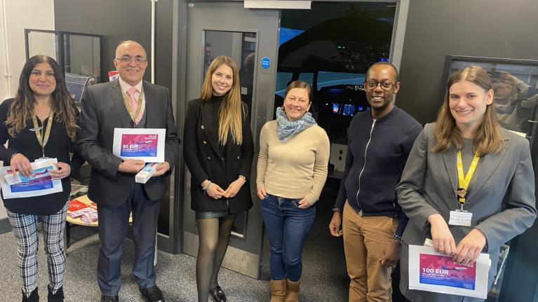 Head of Ancillary Services for Wizz Air James Goodwin, standing with the University’s BSc (Hons) Air Transport Management (Airline and Airport Specialist) students