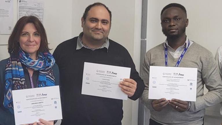 School of Computer and Engineering students standing and holding certificates for winning a competition as part of the Royal Academy of Engineering’s Frontiers Champions 2022 initiative.