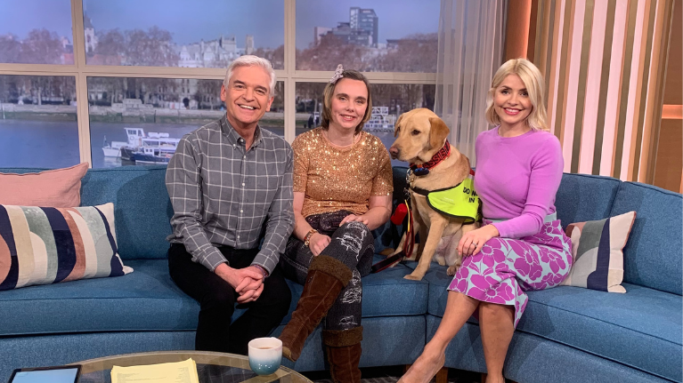 UWL alumna Chloe Hammond sitting on the This Morning couch with Holly Willoughby, Phillip Schofield and her dog, Ocho.