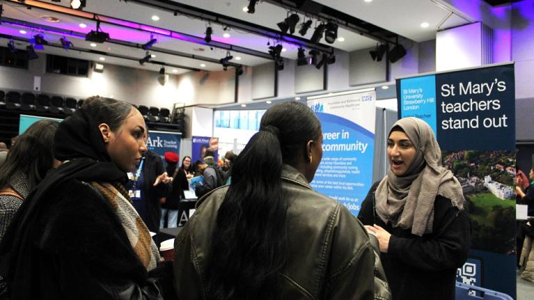 A rep from St Mary's talks with students at UWL's Life and Health Sciences Careers Fair